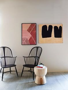 two black chairs sitting next to each other in a room