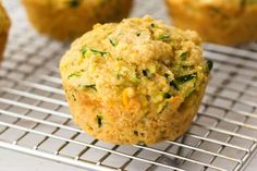 a muffin on a cooling rack with other muffins in the back ground