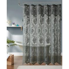 a shower curtain with black and white damasks on the bottom, in front of a