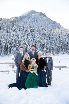 a family posing for a photo in the snow