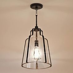 An Urban Ambiance pendant lighting fixture with a beautiful glass shade hanging from the ceiling. Modern Farmhouse Lighting, Outdoor Pendant Lighting, Lantern Design, Urban Loft, Filament Bulb, Farmhouse Lighting, Seeded Glass, Loft Style, Mason Jar Lamp