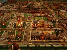 a large model city with lots of buildings and cars on it's sides,