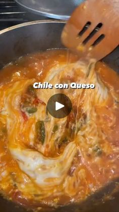 a skillet with some food cooking in it and the words chile con queso