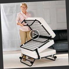 a woman standing next to two folding chairs with wheels on each side and one holding the chair