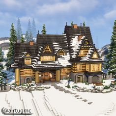 a very big pretty house in the middle of some snow covered hills with trees on each side