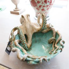 an octopus sculpture sitting on top of a bowl