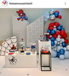 a spiderman themed birthday party with balloons and decorations