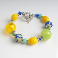 "This Yellow lemon lampwork bracelet is a perfect gift for women. It's very tender and unique! This lampwork bracelet fits a 15.5-16.5cm (6.1\"-6.5\" inch) diameter wrist. If you need bigger or smaller size bracelet, please, write me the diameter of your wrist when making an order. Set Matching earrings: https://www.etsy.com/listing/465042145 Matching necklace: https://www.etsy.com/listing/464057425 Dimentions: 21cm. Materials: artist lampwork beads, metal and glass beads, metal fittings. Colors Summer Casual Jewelry With Fruit Design, Lemon Bead Bracelet, Cheap Playful Jewelry With Fruit Design, Cute Multicolor Fruit Design Jewelry, Cheap Playful Fruit-designed Jewelry, Fruit Bracelet, Kawaii Bracelet, Lampwork Bracelets, Yellow Bracelet