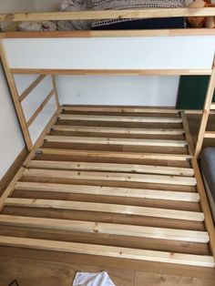 a wooden bunk bed frame with no mattress