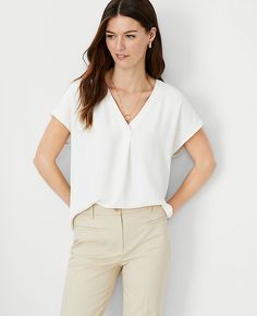 Elevate your wardrobe with the Ann Taylor Mixed Media Pleat Front Top, a masterpiece of design and comfort. This top features:

- Size: XS
- Color: Winter White
- Gender: Female
- Material: Front 100% Polyester; Back 95% Polyester, 5% Spandex
- Fit: Relaxed fit
- Length: 25 1/2" long
- Care Instructions: Machine washable

The cleverly designed V-neck is enhanced with a pleat for added fluidity, while the combination of woven front and sleeves with a knit back ensures both style and comfort. The Comfortable Professional Outfits, Petite Capsule Wardrobe, Uniform Wardrobe, Ann Taylor Petite, Work Fits, Work Flow, Knitted Suit, Hip Style, Flattering Tops