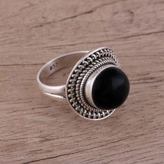 Resting within the crown of this cocktail ring lies an onyx stone of deep black. Sterling silver rope motifs encircle the gemstone. Designed by Alok Jain of India, the ring adds a fascinating accent to any style. Adjustable Silver Onyx Ring, Black Spiritual Round Rings, Onyx Cabochon Round Rings, Onyx Cabochon Rings, Round Onyx Cabochon Rings, Silver Chandelier Earrings, Ruby Pendant, Sterling Silver Dangle Earrings, Onyx Stone