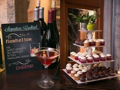 cupcakes and wine on a table with a sign that says manhattan next to it