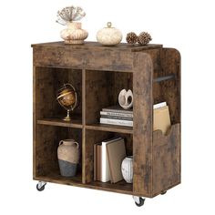 a book shelf with books and other items on it's wheels, against a white background