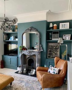 a living room filled with furniture and a fire place in front of a mirror on the wall