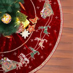 a christmas tree skirt with ornaments on it