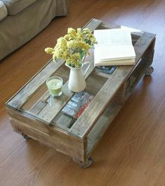 a coffee table with flowers and books on it