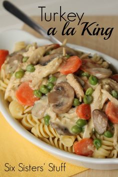 a pasta dish with mushrooms, peas and carrots in a white bowl on a yellow napkin