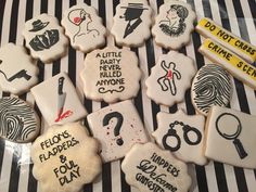 decorated cookies with different types of fingerprints and words on them, all in black and white