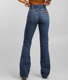 Wrangler® Westward High Rise Boot Jean - Blue 31/32, Women's Woodcreek This figure-flattering bootcut is easy on the eyes with a flattering high waist to balance out the dramatic leg for uncompromising comfort and good looks. High rise Stretch fabric Slim through the hip and thigh 19 bottom opening Destructed pocket and hem details Shoe sku 960210 Model Info: Height: 5'5 | Bust: 34 | Waist: 24 | Hip: 35 | Wearing Size: 25x34. This quality denim is hand-finished for a unique look. It will wear li Wrangler Trumpet Flare Jeans, Wrangler Wide Leg Jeans, Wrangler Pants Women, High Waisted Wrangler Jeans, Styling Wrangler Jeans, Bootcut Jeans Western, Cowgirl Jeans Wrangler, High Waisted Western Jeans, Women’s Wrangler Jeans Outfit