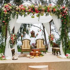 an outdoor wedding setup with chairs and flowers