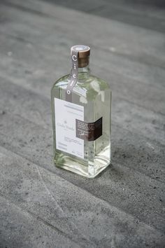 a bottle of alcohol sitting on the ground