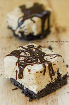 two pieces of cake sitting on top of a wooden table