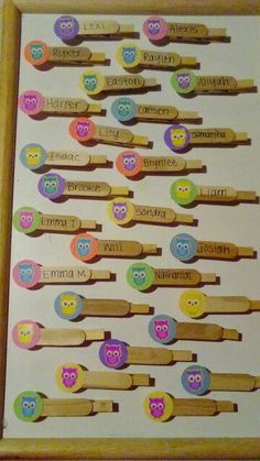 an assortment of wooden spoons with owls on them and name tags attached to them