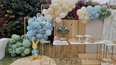 a table topped with balloons and cake