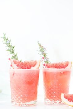 two grapefruit cocktails with rosemary garnish on the rim and one filled with watermelon