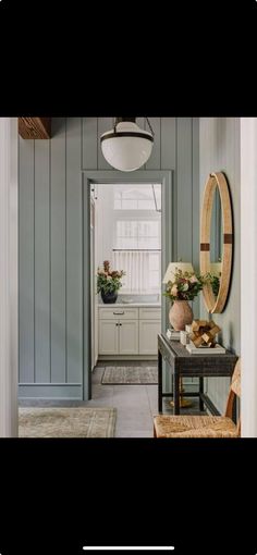 a hallway with blue walls and white trim on the walls is shown in this image