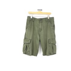 Here is a pair of vintage Levi cargo shorts.  Snap closures on the pockets. One uber tiny spot in the front on the right side by the groin.  Not noticeable.  There is only one tag on the inside.  The other tag looks to be ripped out.   Measurements Waist 34 in Hips 42 in Inseam 11.5 in Length 24.5 in Military Style Cotton Cargo Shorts With Patch Pockets, Vintage Cargo Pants With Pockets For Summer, Vintage Cotton Cargo Shorts With Pockets, Vintage Summer Cargo Pants With Pockets, Military Khaki Shorts With Pockets, Green Short Cargo Pants With Patch Pockets, Khaki Bermuda Cargo Shorts With Pockets, Vintage Summer Cargo Pants With Cargo Pockets, Vintage Summer Cargo Pants