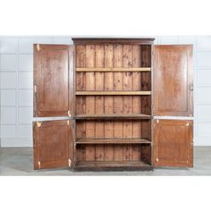 an old wooden bookcase with doors open