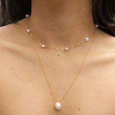 Look no further for an elegant, timeless classic. This Essa Pearl Pendant Necklace showcases a perfectly imperfect freshwater pearl, guaranteed to bring any ensemble to the next level. An effortless piece that will never go out of style! Details: Gold: 925 Sterling Silver, 18K Gold Plated, Freshwater Pearl Silver: 925 Sterling Silver, Rhodium Plated, Freshwater Pearl Pearl Size: 12.5mm - 13.5mm Classic Double Strand Pearl Necklace With Pendant, Classic Double Strand Pearl Pendant Necklace, Classic Akoya Pearl Necklace With Delicate Chain, Classic White Necklace For Layering, Classic Double Strand Pearl Pendant Jewelry, Classic Double Strand Necklace With Pearl Pendant, Classic Pearl Necklace With Delicate Chain, Classic Double Strand Pearl Chain Necklace, Classic Pearl White Necklace With Delicate Chain