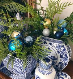 blue and white vases filled with christmas ornaments