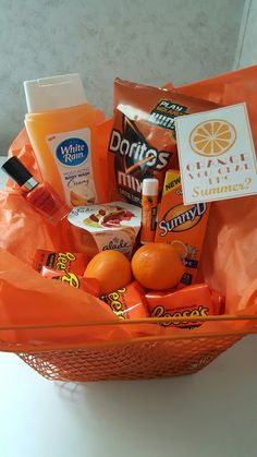 an orange basket filled with snacks and drinks