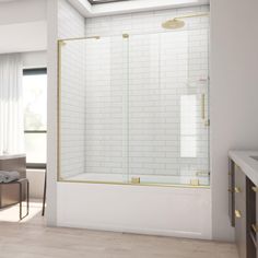 a bathroom with white tile and gold trimmings on the shower door, toilet and bathtub