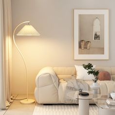 a living room filled with furniture and a white lamp on top of a glass table