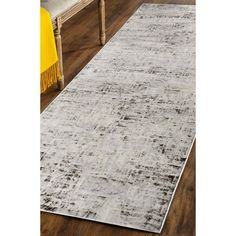 a white rug on top of a wooden floor