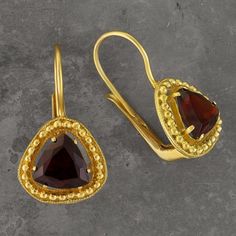 "Victorian artisans made the most of blue and gold. Here a faceted garnet stone is encircled by beads of gold vermeil 24k gold over sterling silver. European lever-backs for pierced ears. Length: 1 \" tall." Faceted Garnet Jewelry In Yellow Gold, Elegant Gold Garnet Earrings, Gold Garnet Gemstone Jewelry, Gold Jewelry With Garnet Birthstone, Gold Garnet Birthstone Jewelry, Gold Faceted Earrings For Anniversary, Gold Gemstone Earrings For Formal Occasions, Gold Garnet Jewelry With Birthstone, 22k Gold Gemstone Earrings For Formal Occasions