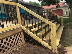 a wooden stair case next to a fence