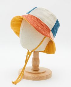 Meet the Checkered Baby Bucket Hat—a sunny-day essential that combines stand-out style and thoughtful design. Crafted from 100% organic cotton and azo free dyes, this hat features a cheerful checkered pattern in a rainbow palette that adds a playful pop to any outfit. The 2" brim provides the perfect amount of shade while adding an extra dose of cuteness, and the cotton toggle ensures a snug fit without any plastic hardware. It’s designed to stay put on even the busiest little explorers. Pairs p Baby Bucket Hat, Rainbow Palette, Vintage Kantha Quilts, Pillow Fabric, Fabric Baskets, Vintage Kantha, Linen Shop, Quilted Pillow, Kantha Quilt