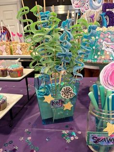 a table topped with cupcakes and cake pops