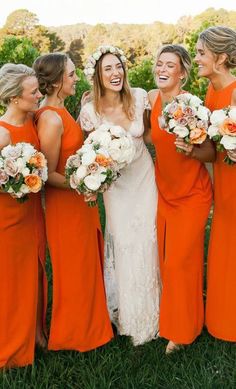 a group of women standing next to each other holding bouquets