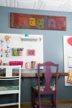 a purple chair sitting in front of a desk with writing on the wall above it