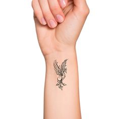 a woman's arm with a small tattoo design on the left side of her wrist