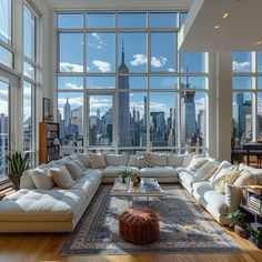 a living room filled with lots of furniture and large windows overlooking the cityscape