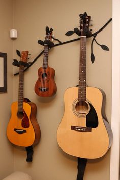 two guitars are hanging on the wall