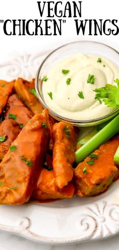 a plate with chicken wings, celery sticks and ranch dressing on it that says vegan'chicken wings