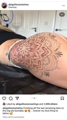 a woman laying on top of a bed covered in tattoos