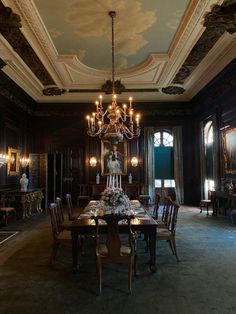 an elegant dining room with chandelier and chairs